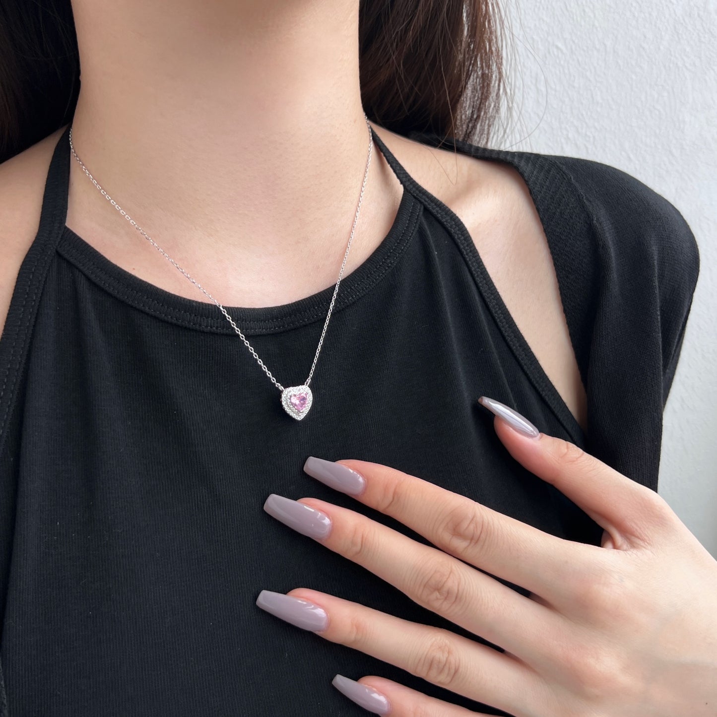 Heart design necklace with decorative stones.