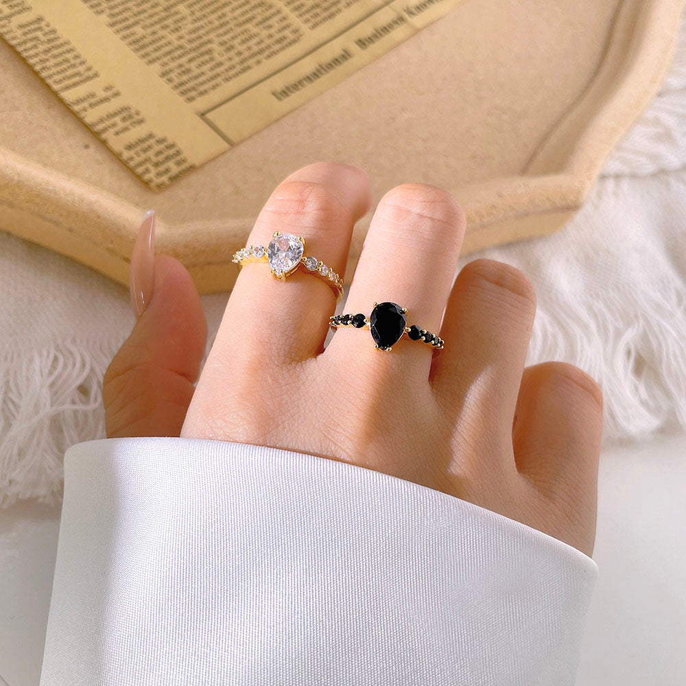 A gold ring with Oval and Side stones